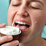 **

*   Prompt: Dental implant patient with swollen cheek, applying ice pack. Emphasis on pain relief, possibly with pain medication nearby. Soft foods (yogurt, soup) visible in the background.

**